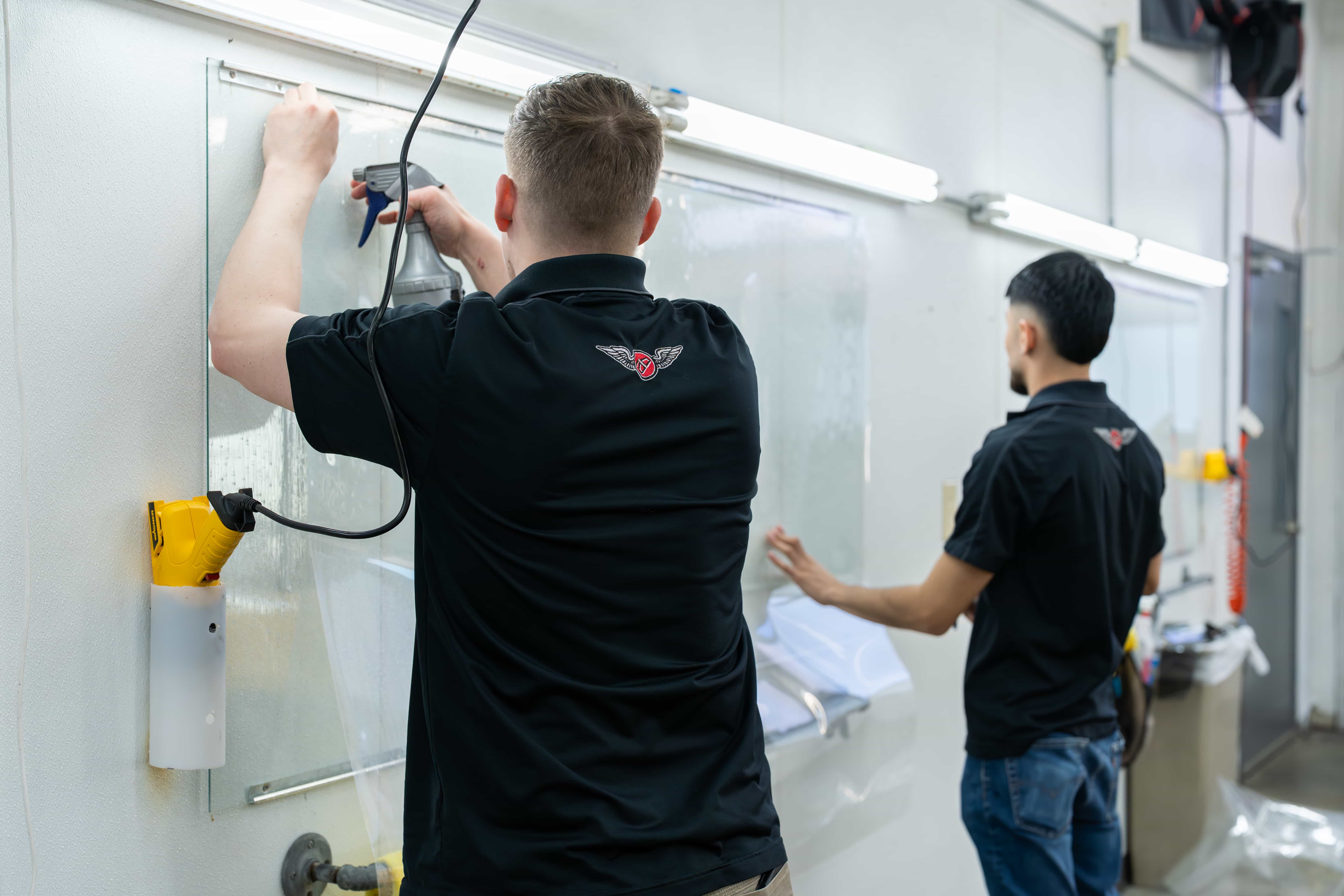 Accutint team members prepping window tint