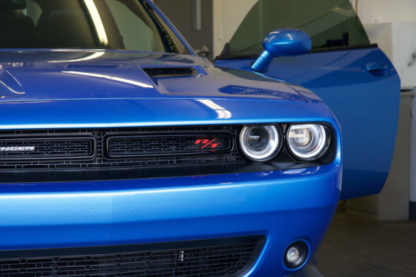 A blue Dodge Challenger with professionally tinted windows
